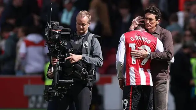 Keith Andrews, Manager of Brentford and Dango Ouattara embrace at full-time
