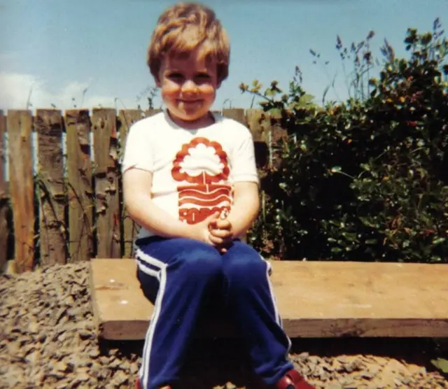 Young Nottingham forest fan wearing a Forest shirt.