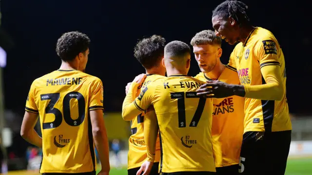 Newport County players celebrate a goal