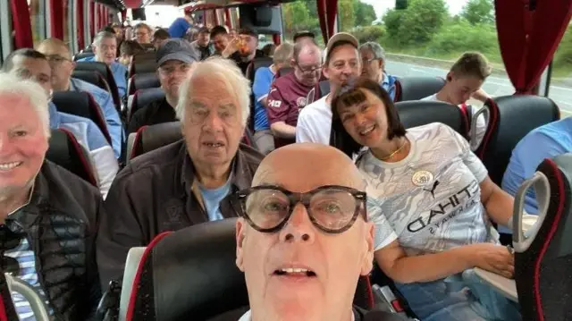 A group of Manchester City travelling supporters pose for a picture
