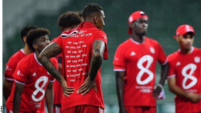 Bayern Munich's players wore red T-shirts after full-time with the number eight on them to mark the club winning the Bundesliga between 2013 and 2020