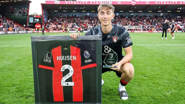 Real Madrid-bound Dean Huijsen poses with a shirt signed by his Bournemouth teammates