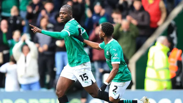 Plymouth Argyle's Mustapha Bundu celebrates by pointing alongside team-mate Bali Mumba after scoring against Derby