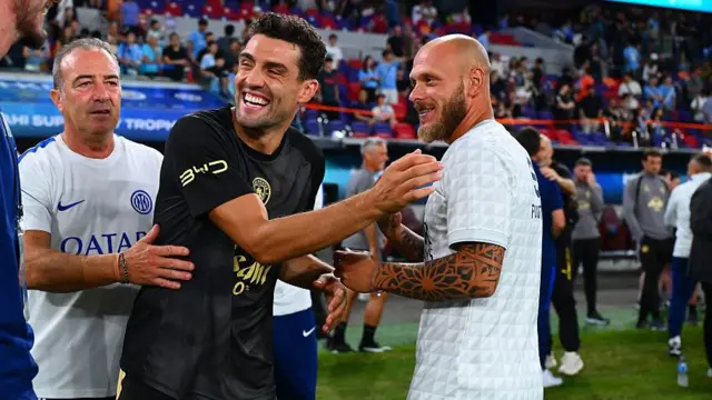 Mateo Kovacic laughs as he shakes hands with players