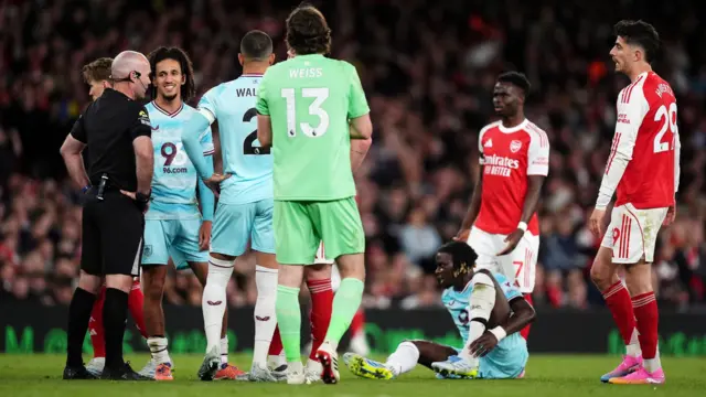 Arsenal and Burnley players speak to the referee