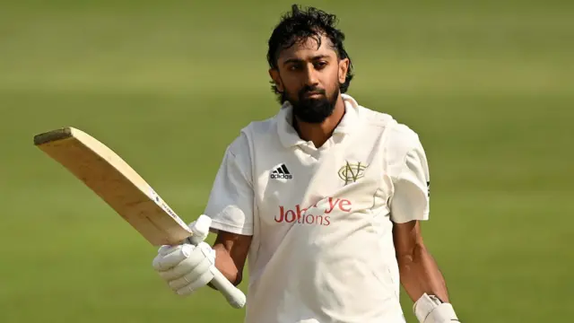Nottinghamshire captain Haseeb Hameed raises his bat after hitting a double century