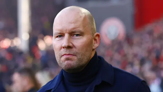 Henrik Pedersen wearing a smart jacket and a rollover navy jumper at the Steel City derby