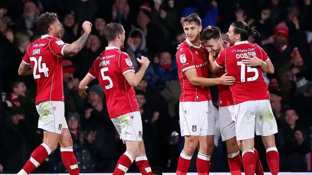 Wrexham players Dan Scarr, Dom Hyam, Max Cleworth, George Thomason and George Dobson celebrate