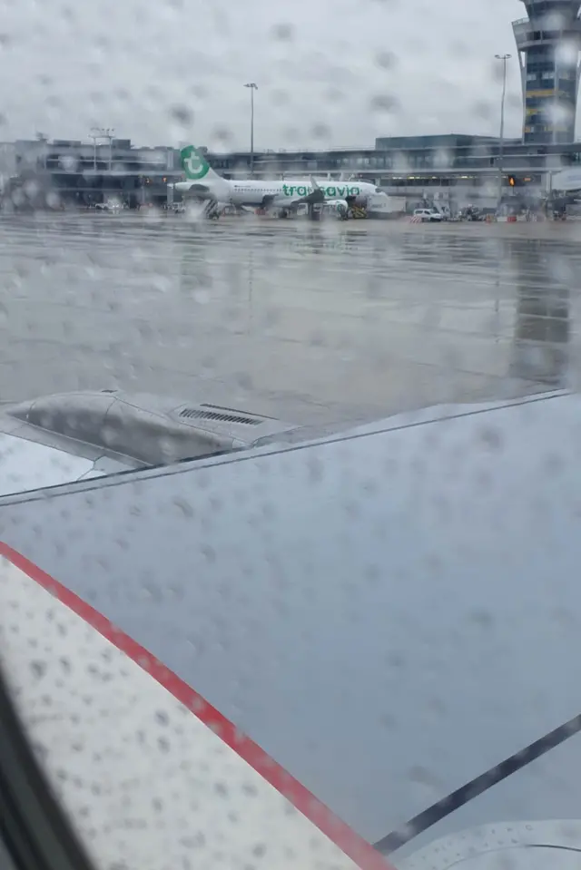 A rain-spattered window out of an aeroplane