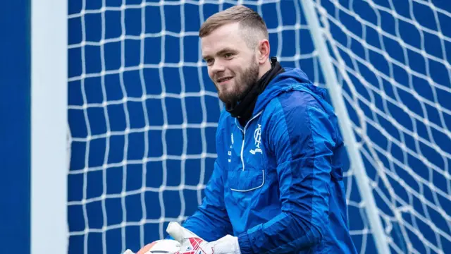 Goalkeeper Andy Firth pictured in training whilst with Rangers, dressed in blue training top and standing in front of the net.