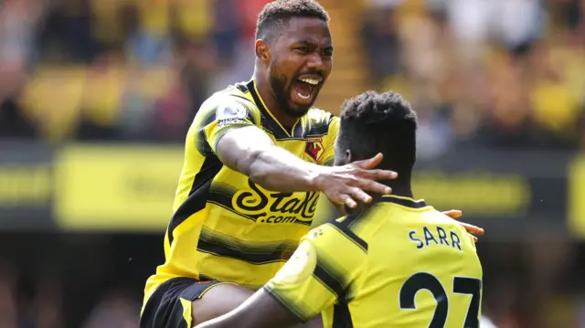 Emmanuel Dennis and Ismaila Sarr celebrate Dennis' goal against Aston Villa