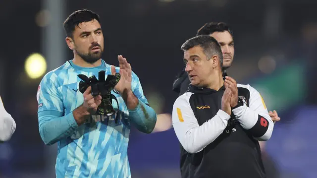 Newport County goalkeeper Nick Townsend (L) and head coach Nelson Jardim applaud fans