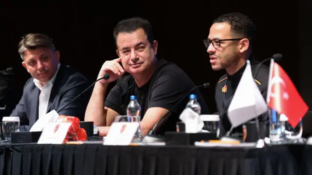 Liam Rosenior speaks during a Hull City press conference in Antalya, Turkey in March 2024. Hull City's owner Acun Ilicali and vice president Tan Kesler are sat alongside him. 
