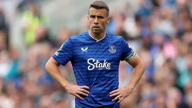 Seamus Coleman standing with his hands on his hips during an Everton match