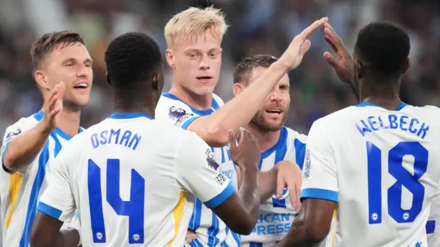 Brighton players celebrate a goal against Tokyo Verdy