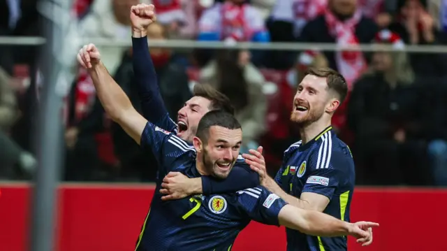 Scotland's John McGinn celebrates with teammates after scoring to make it 1-0 during the UEFA Nations League 2024/25 League A Group A1 match between Poland and Scotland at the PGE Narodowy