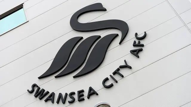 A Swansea city crest on the side of their stadium