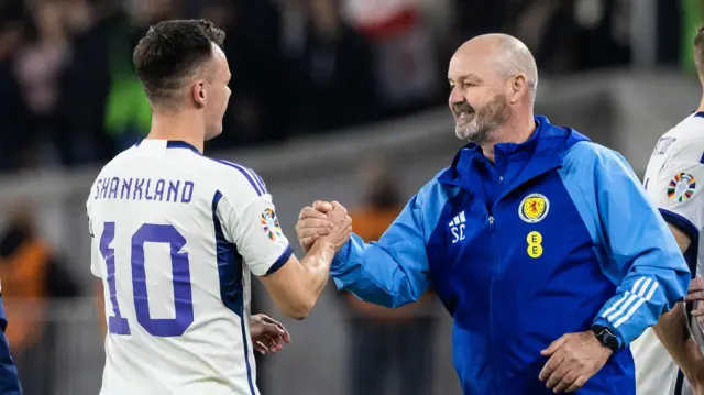 Lawrence Shankland shakes Steve Clarke's hand when coming off the pitch