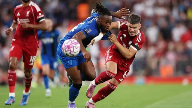 Antoine Semenyo and Milos Kerkez of Liverpool battle for possession 