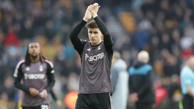 Fulham captain Tom Cairney is applauding the fans after the Premier League match between Wolverhampton Wanderers and Fulham at Molineux in Wolverhampton