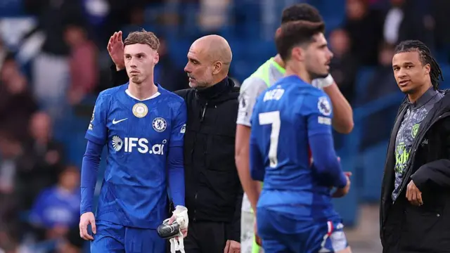 Pep Guardiola interacts with Cole Palmer
