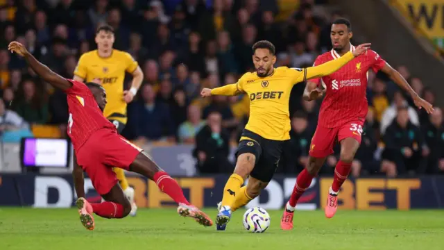 Matheus Cunha of Wolverhampton Wanderers in action with Ibrahima Konate and Ryan Gravenberch of Liverpool during the Premier League match between Wolverhampton Wanderers FC and Liverpool FC at Molineux