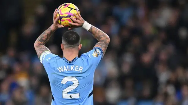 An image of Kyle Walker's back as he prepares to take a throw-in for Manchester City