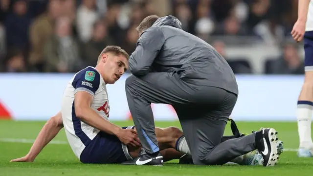 Micky Van de Ven with a Tottenham physio