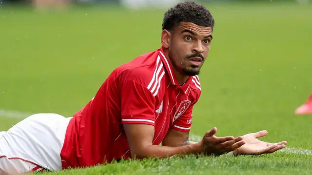 Morgan Gibbs-White lies on the ground