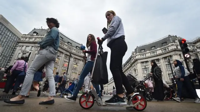 commuter uses a scooter to make her way home during the tube strike