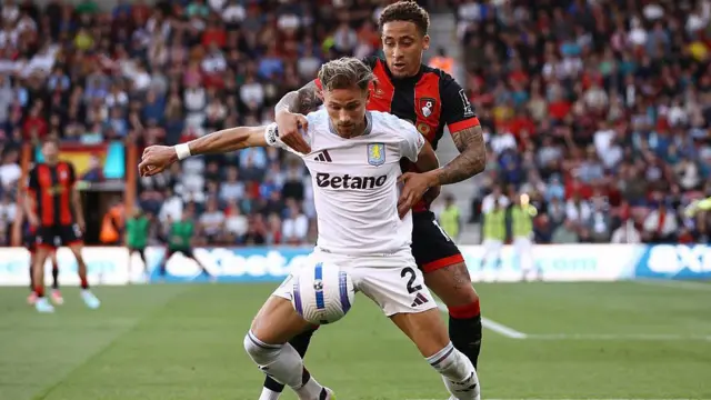 Matty Cash of Aston Villa is challenged by Marcus Tavernier of AFC Bournemouth.
