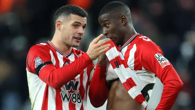 Granit Xhaka speaks to a team-mate