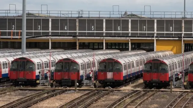 Piccadilly Line tube trains are parked at the Northfields Depot