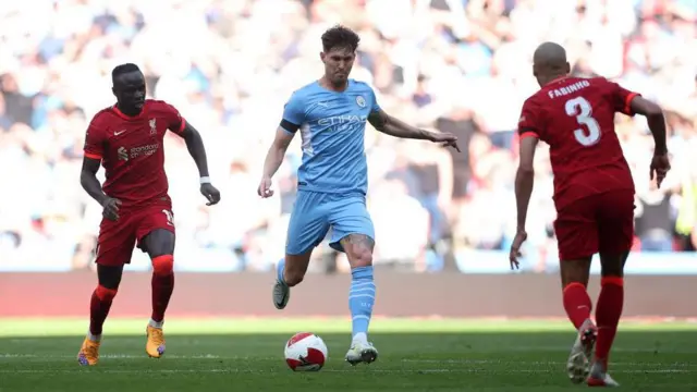John Stones of Manchester City is marked by Fabinho of Liverpool 