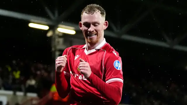 Wrexham midfielder Lewis O'Brien celebrates