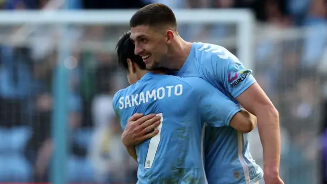 Bobby Thomas hugs his team-mate 