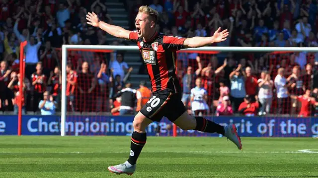 Matt Ritchie, arms spread out, celebrating a goal for Bournemouth