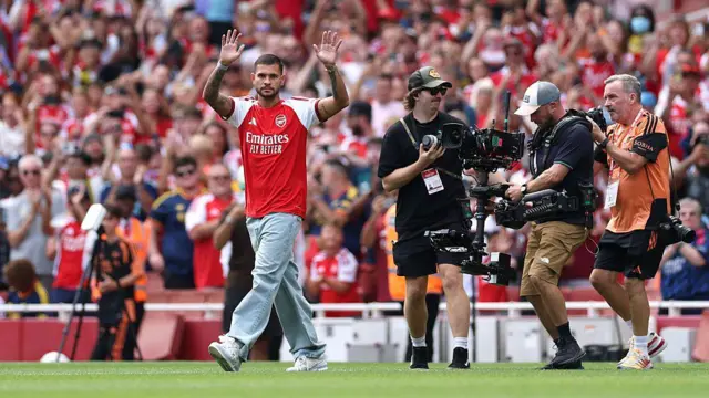 Bruno Guimaraes of Arsenal waves to fans as he is unveiled