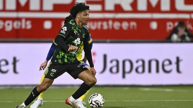 Oluwaseun Adewumi in action for Cercle Bruges wearing a black and green playing shirt, black shorts and black socks