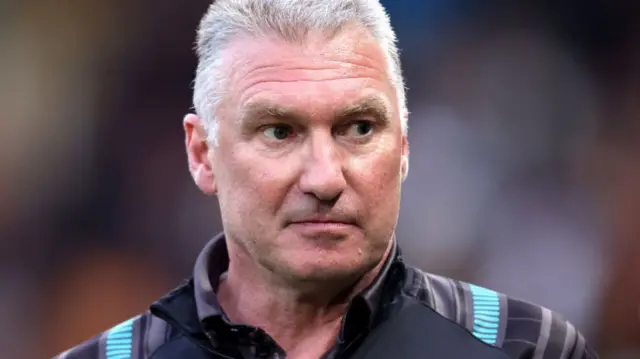 Nigel Pearson with his eyebrows raised as he looks to the side