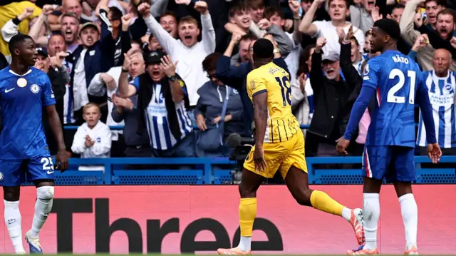 Danny Welbeck celebrates scoring in front of fans against Chelsea