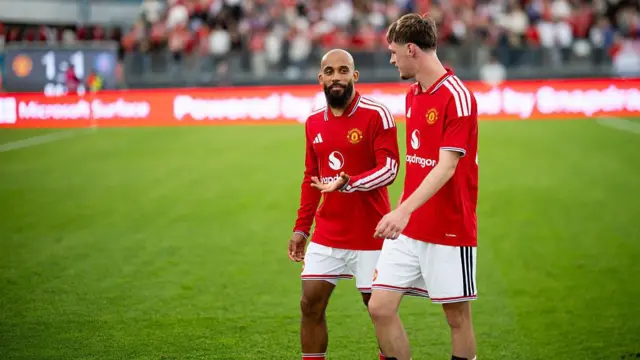 Bryan Mbuemo and Tyler Fletcher of Manchester United walk off the pitch