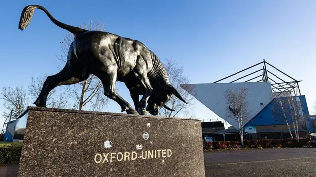 A general view of the outside of Oxford United's Kassam Stadium with a statue of an Ox in the foreground