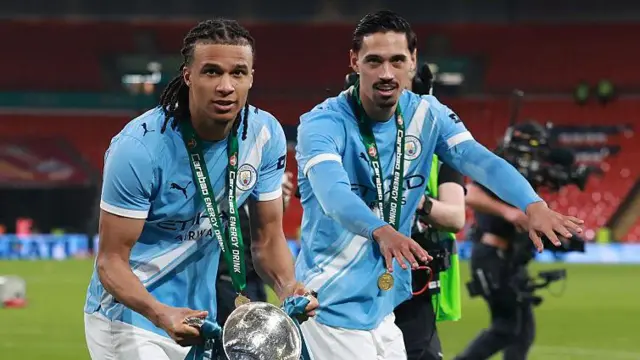 Nathan Ake and Tijjani Reijnders of Manchester City celebrate with the Carabao Cup trophy