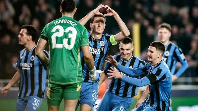 Club Brugge players celebrate their goal against Aston Villa