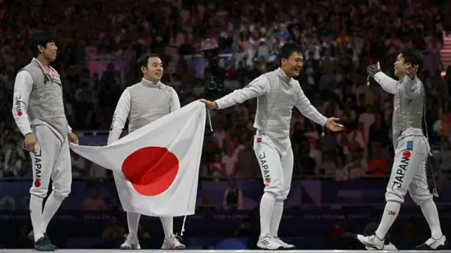 Japan fencing team celebrate