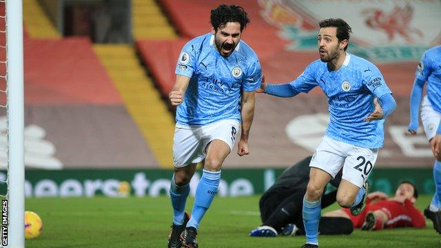 Ilkay Gundogan of Manchester City (left) celebrates with team-mate Bernardo Silva after scoring against Liverpool