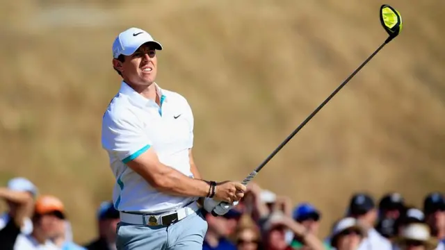 Rory McIlroy watches after his shot