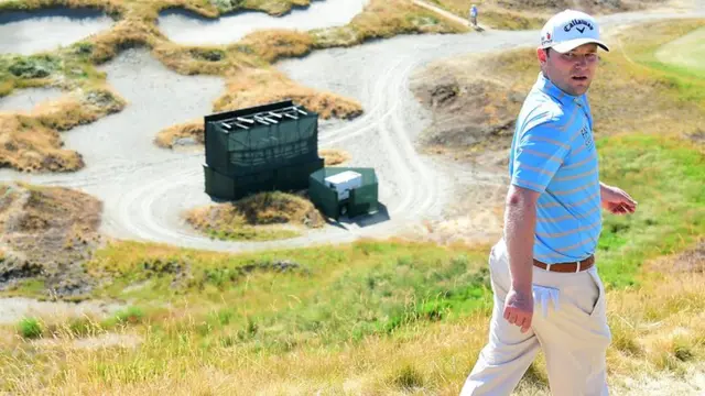 Branden Grace walks along the course