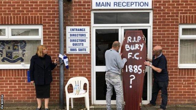 In one of the most evocative images of the downfall of Bury FC, Joy Hart chained herself to the stand which bears her father's name at their Gigg Lane home while fans later carried in a ceremonial coffin